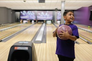 Big for a Day with credit union a waiting little enjoying the thrill of bowling